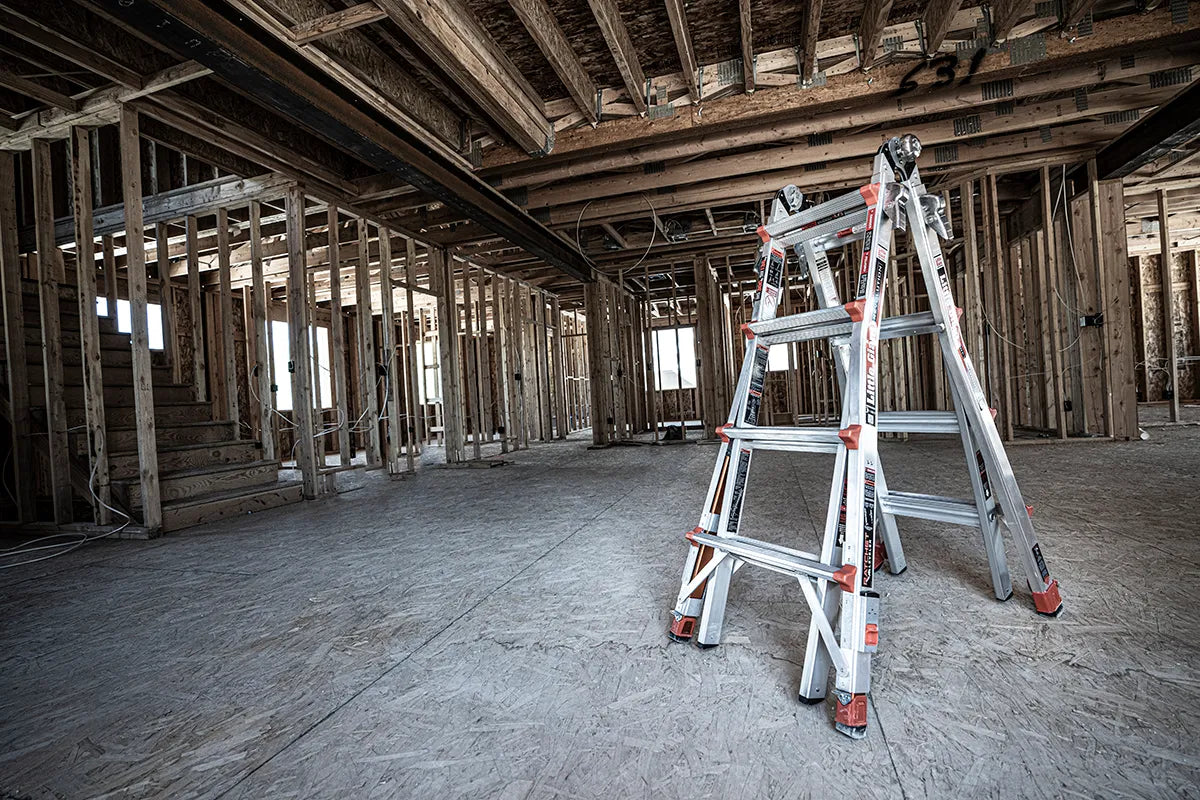 Ladder leaning against a wooden framework of a building under construction.